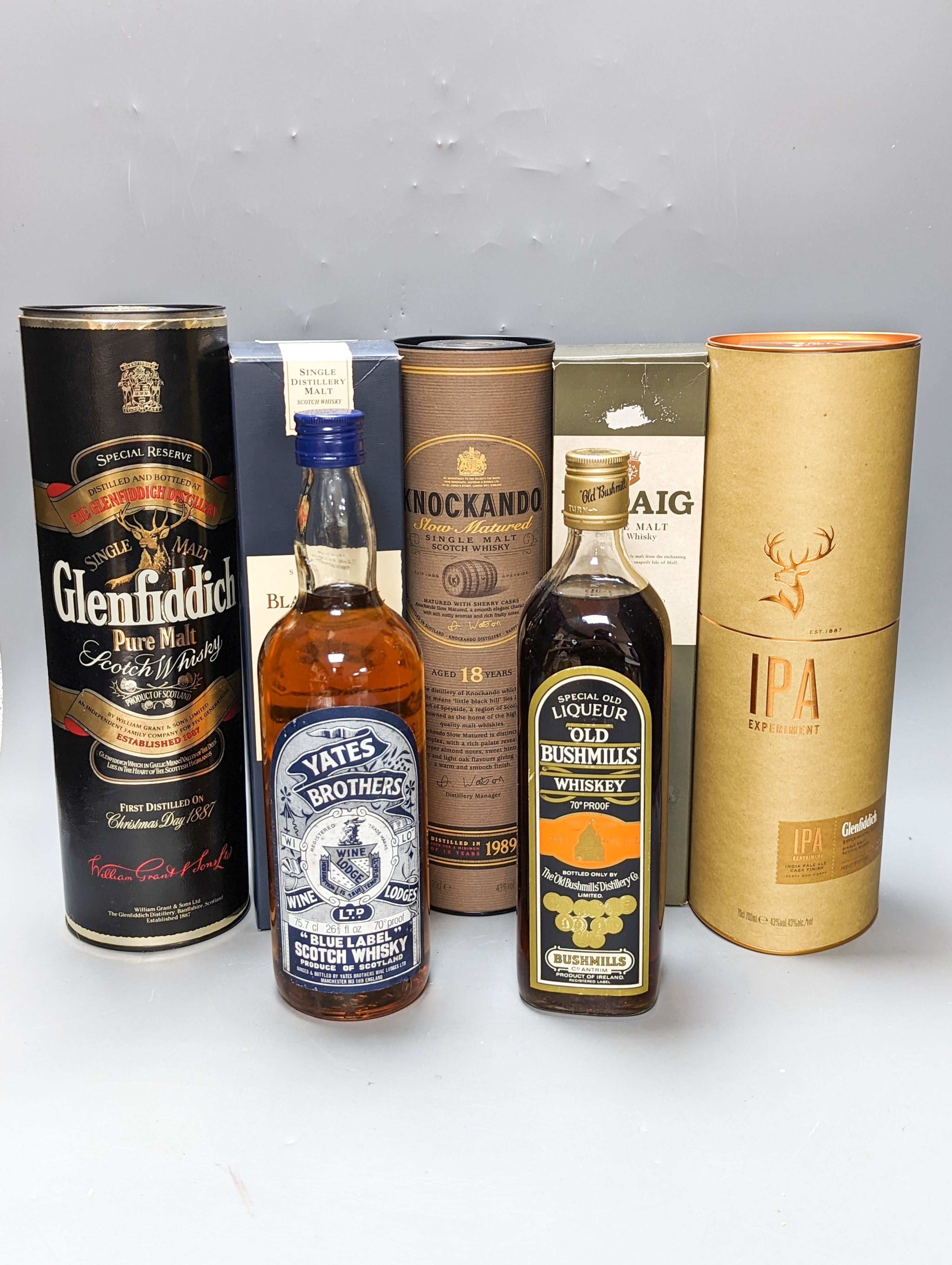 Seven assorted bottles of whisky including Yates Brothers, Bushwalls, IPA single malt, Blair Athol 12 year old single malt, Ledaig single malt, Knockando 18 year old malt and Glenfiddich malt, five boxed.
